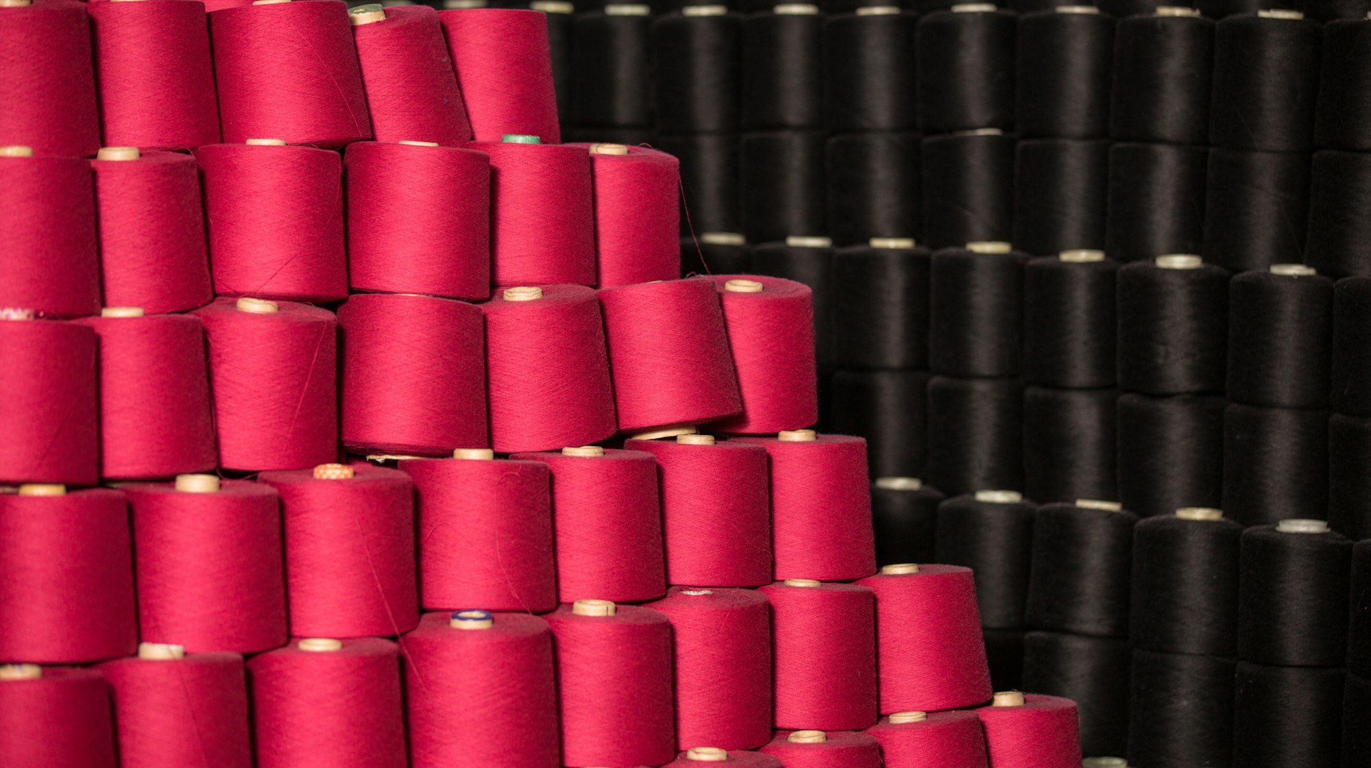 Red and black yarn cones ready for knitting